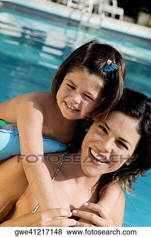 Portrait of a mother smiling with her daughter View Large Photo Image Stock Photo - Portrait of a mother smiling with her daughter. Fotosearch