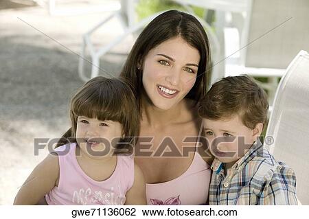 Portrait of a mother with her two children View Large Photo Image Stock Image - Portrait of a mother with her two children. Fotosearch