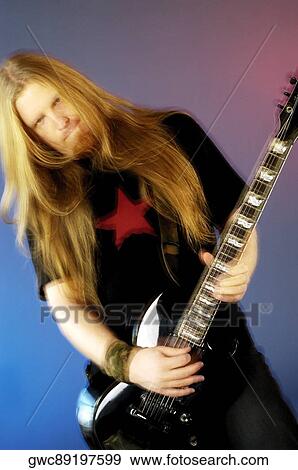Portrait of a musician playing the electric guitar View Large Photo Image Stock Photo - Portrait of a musician playing the electric guitar. Fotosearch