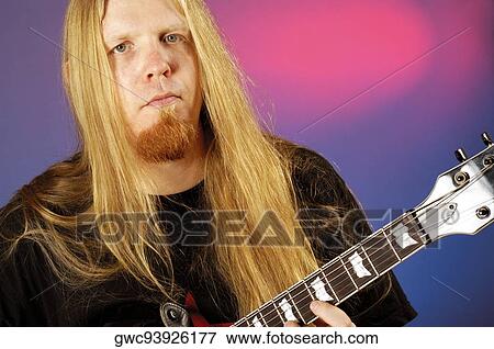 Stock Photo - Portrait of a musician playing the electric guitar. Fotosearch