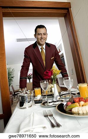 Portrait of a waiter serving food View Large Photo Image Stock Image - Portrait of a waiter serving food. Fotosearch