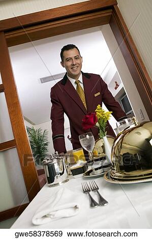 Portrait of a waiter serving food View Large Photo Image Stock Photo - Portrait of a waiter serving food. Fotosearch