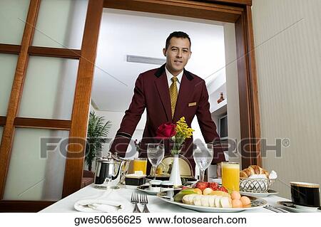 Portrait of a waiter serving food View Large Photo Image Stock Photography - Portrait of a waiter serving food. Fotosearch