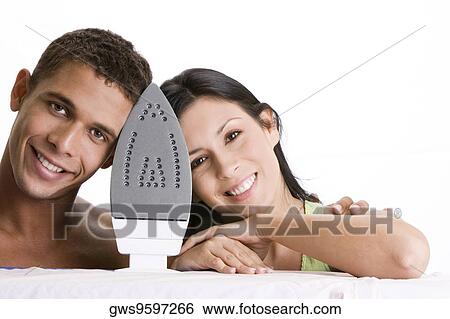 Portrait of a young couple behind an iron View Large Photo Image Stock Photograph - Portrait of a young couple behind an iron. Fotosearch