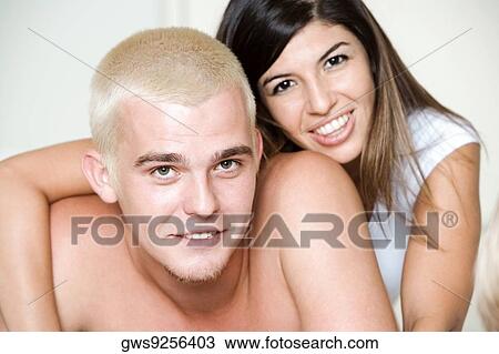 Stock Image - Portrait of a young couple smiling. Fotosearch