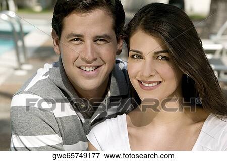 Stock Photo - Portrait of a young couple smiling. Fotosearch