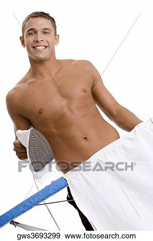 Portrait of a young man holding an iron View Large Photo Image Stock Photo - Portrait of a young man holding an iron. Fotosearch