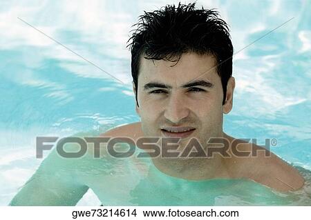 Picture - Portrait of a young man in a swimming pool. Fotosearch