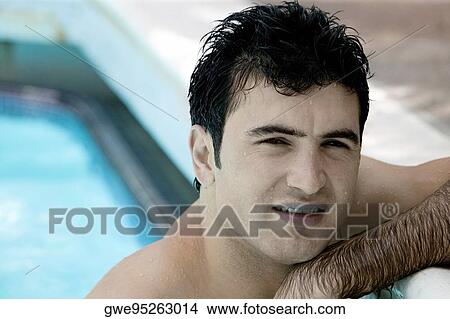 Portrait of a young man in a swimming pool View Large Photo Image Picture - Portrait of a young man in a swimming pool. Fotosearch