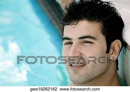 Portrait of a young man in a swimming pool View Large Photo Image Stock Image - Portrait of a young man in a swimming pool. Fotosearch