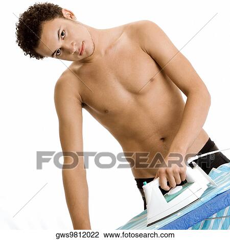Portrait of a young man ironing View Large Photo Image Stock Image - Portrait of a young man ironing. Fotosearch