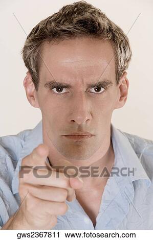 Portrait of a young man pointing forward View Large Photo Image Stock Image - Portrait of a young man pointing forward. Fotosearch