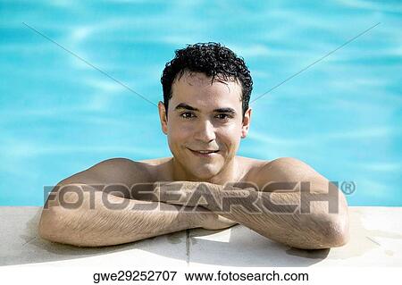 Portrait of a young man smiling in a swimming pool View Large Photo Image Stock Photo - Portrait of a young man smiling in a swimming pool. Fotosearch