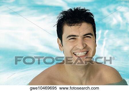 Portrait of a young man smiling in a swimming pool View Large Photo Image Stock Photography - Portrait of a young man smiling in a swimming pool. Fotosearch