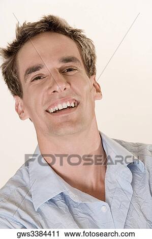Portrait of a young man smiling View Large Photo Image Stock Image - Portrait of a young man smiling. Fotosearch