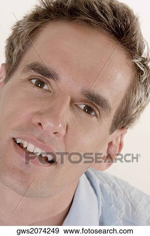 Portrait of a young man smiling View Large Photo Image Stock Photo - Portrait of a young man smiling. Fotosearch
