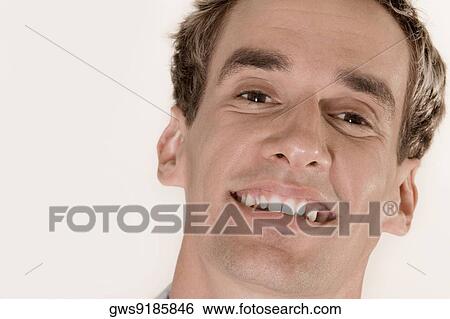 Portrait of a young man smiling View Large Photo Image Stock Photograph - Portrait of a young man smiling. Fotosearch