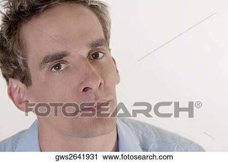 Stock Image - Portrait of a young man thinking. Fotosearch