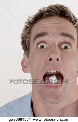 Portrait of a young man with candy in his mouth View Large Photo Image Picture - Portrait of a young man with candy in his mouth. Fotosearch