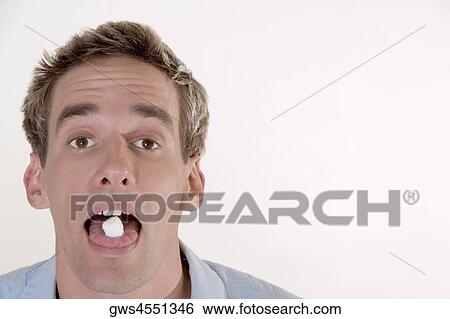 Portrait of a young man with candy in his mouth View Large Photo Image Stock Photograph - Portrait of a young man with candy in his mouth. Fotosearch