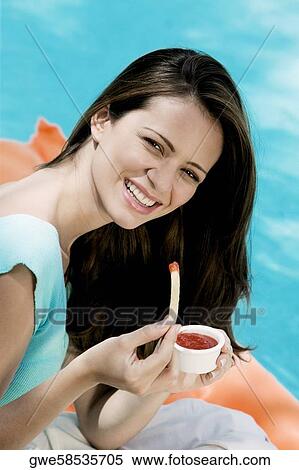 Portrait of a young woman eating french fries View Large Photo Image Stock Photography - Portrait of a young woman eating french fries. Fotosearch