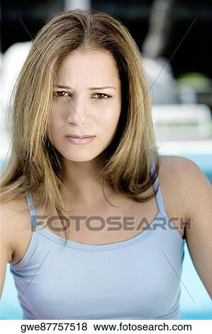 Portrait of a young woman frowning View Large Photo Image Stock Photo - Portrait of a young woman frowning. Fotosearch