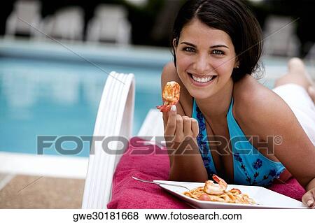 Portrait of a young woman having a meal View Large Photo Image Stock Photo - Portrait of a young woman having a meal. Fotosearch