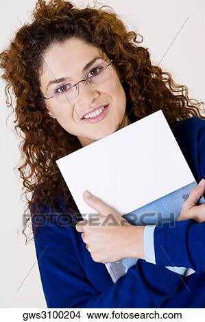 Picture - Portrait of a young woman holding a book. Fotosearch