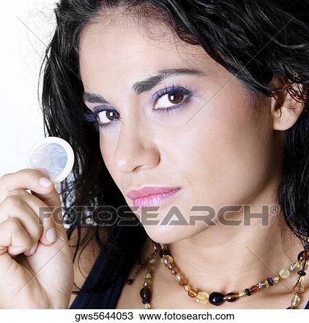 Portrait of a young woman holding a condom View Large Photo Image Stock Image - Portrait of a young woman holding a condom. Fotosearch