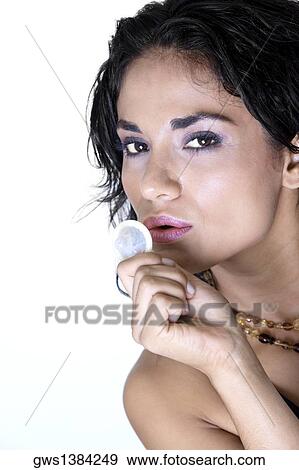 Portrait of a young woman holding a condom View Large Photo Image Stock Photo - Portrait of a young woman holding a condom. Fotosearch