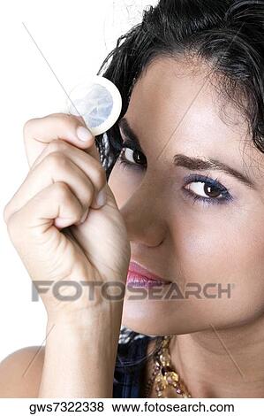 Portrait of a young woman holding a condom View Large Photo Image Stock Photo - Portrait of a young woman holding a condom. Fotosearch
