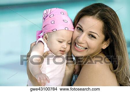 Picture - Portrait of a young woman holding her daughter. Fotosearch