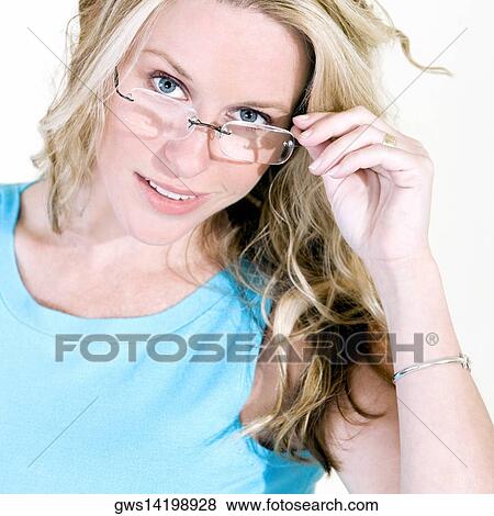 Portrait of a young woman holding her eyeglasses View Large Photo Image Stock Photo - Portrait of a young woman holding her eyeglasses. Fotosearch