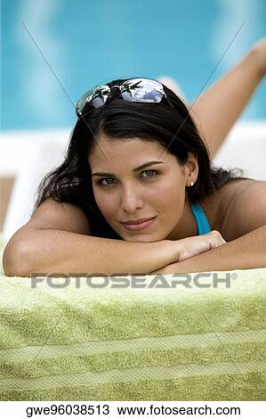 Portrait of a young woman lying on front View Large Photo Image Stock Image - Portrait of a young woman lying on front. Fotosearch