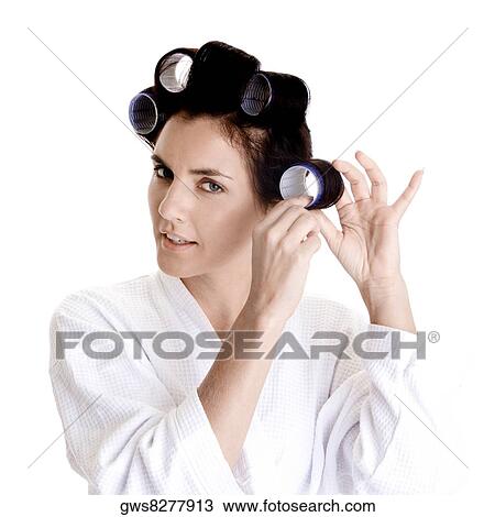 Portrait of a young woman putting a curler in her hair View Large Photo Image Stock Image - Portrait of a young woman putting a curler in her hair. Fotosearch