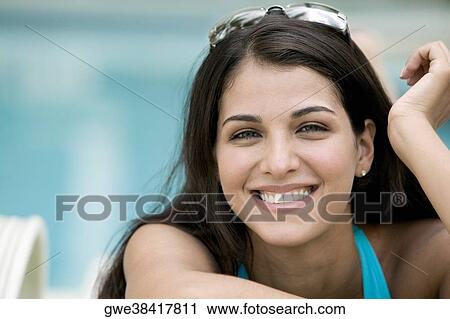 Stock Image - Portrait of a young woman smiling. Fotosearch