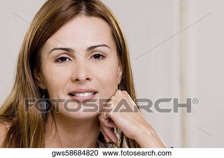Portrait of a young woman smiling View Large Photo Image Stock Image - Portrait of a young woman smiling. Fotosearch