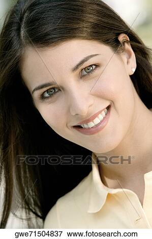 Portrait of a young woman smiling View Large Photo Image Stock Photo - Portrait of a young woman smiling. Fotosearch