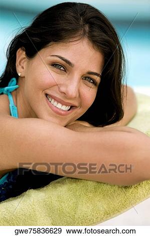 Portrait of a young woman smiling View Large Photo Image Stock Photo - Portrait of a young woman smiling. Fotosearch