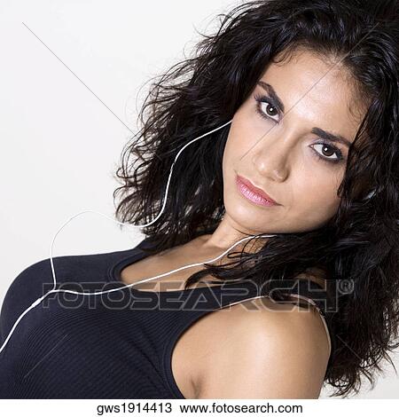 Portrait of a young woman wearing headphones listening to music View Large Photo Image Stock Image - Portrait of a young woman wearing headphones listening to music. Fotosearch