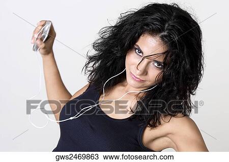 Portrait of a young woman wearing headphones listening to music View Large Photo Image Stock Image - Portrait of a young woman wearing headphones listening to music. Fotosearch