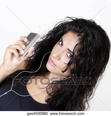 Portrait of a young woman wearing headphones listening to music View Large Photo Image Stock Photography - Portrait of a young woman wearing headphones listening to music. Fotosearch