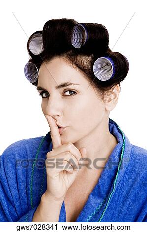 Portrait of a young woman with curlers in her hair and a finger on her lips View Large Photo Image Stock Image - Portrait of a young woman with curlers in her hair and a finger on her lips. Fotosearch