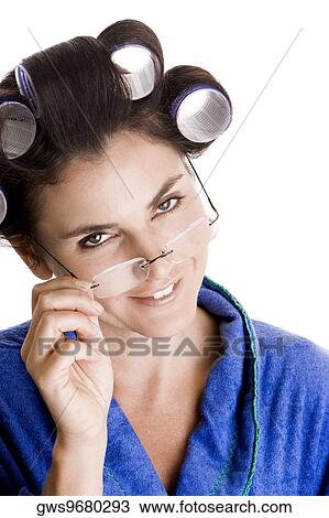 Portrait of a young woman with curlers in her hair adjusting her eyeglasses View Large Photo Image Stock Image - Portrait of a young woman with curlers in her hair adjusting her eyeglasses. Fotosearch