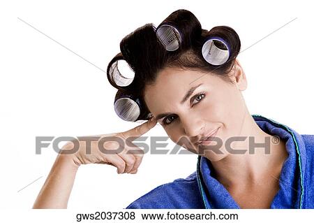 Stock Photo - Portrait of a young woman with curlers in her hair. Fotosearch
