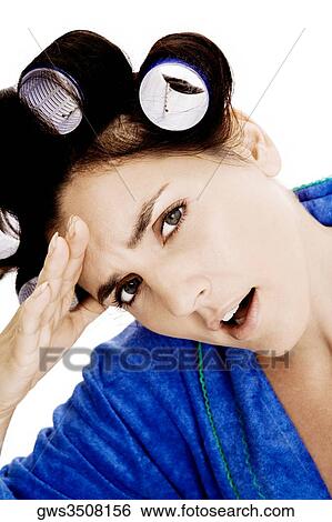 Portrait of a young woman with curlers in her hair and her hand on her forehead View Large Photo Image Stock Photograph - Portrait of a young woman with curlers in her hair and her hand on her forehead. Fotosearch