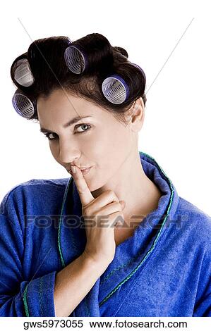 Portrait of a young woman with curlers in her hair and a finger on her lips View Large Photo Image Stock Photography - Portrait of a young woman with curlers in her hair and a finger on her lips. Fotosearch