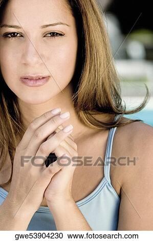 Portrait of a young woman with her hands clasped View Large Photo Image Stock Image - Portrait of a young woman with her hands clasped. Fotosearch
