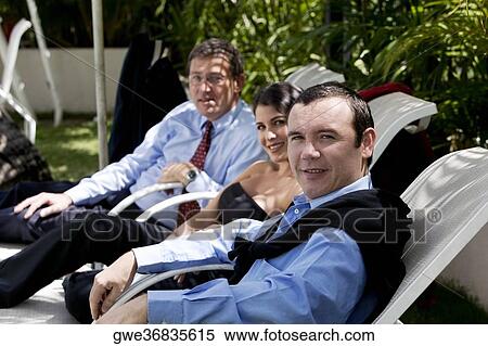 Portrait of two businessmen and a businesswoman sitting View Large Photo Image Stock Photography - Portrait of two businessmen and a businesswoman sitting. Fotosearch