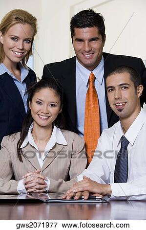 Portrait of two businessmen and two businesswomen smiling View Large Photo Image Stock Photo - Portrait of two businessmen and two businesswomen smiling. Fotosearch